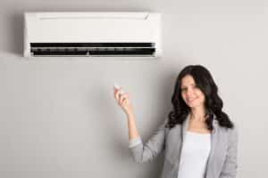 Woman Adjusting AC Temperature